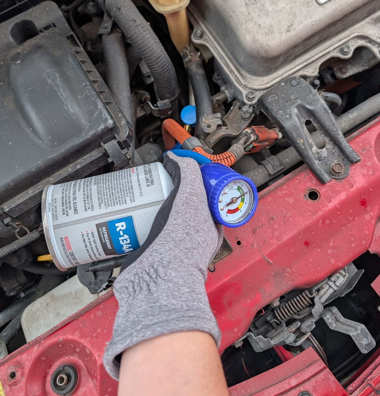 R-134a can rotated 90 degrees while dispensing refrigerant into the low-side port